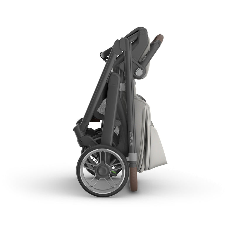 Compact folded Uppababy v3 stroller cruz Savannah, showing one handed fold and easy transport capability