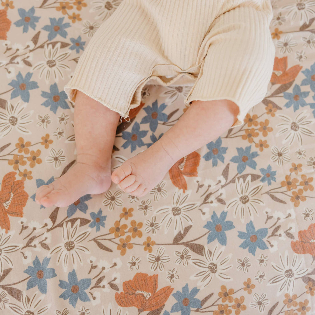 Copper Pearl Eden 46x46 muslin-style knit swaddle blanket in soft gender-neutral tones