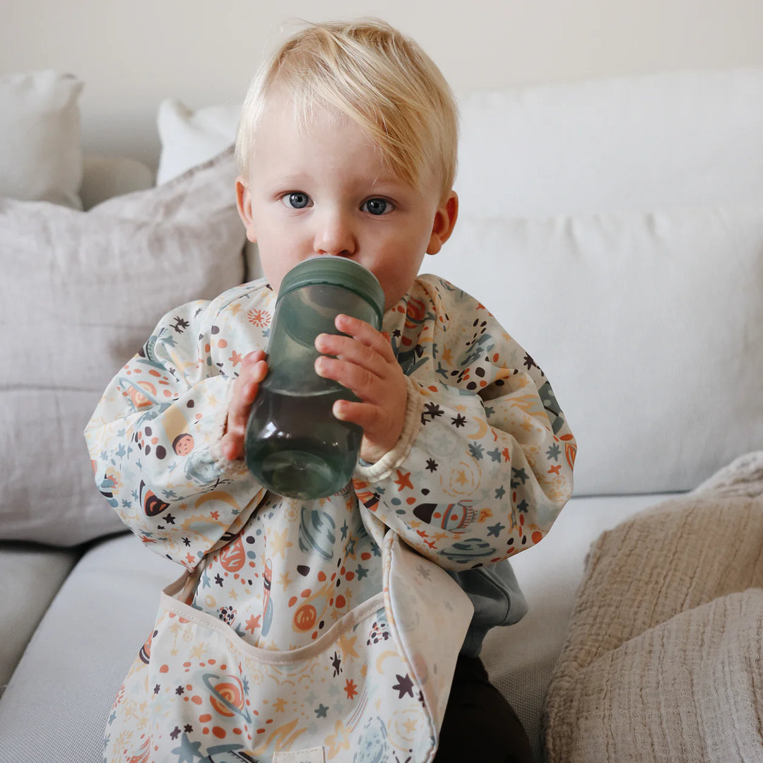 Mushie Soft Spout Sippy Cup space shoot lifestyle - toddler drinking from BPA-free spill-resistant sippy cup