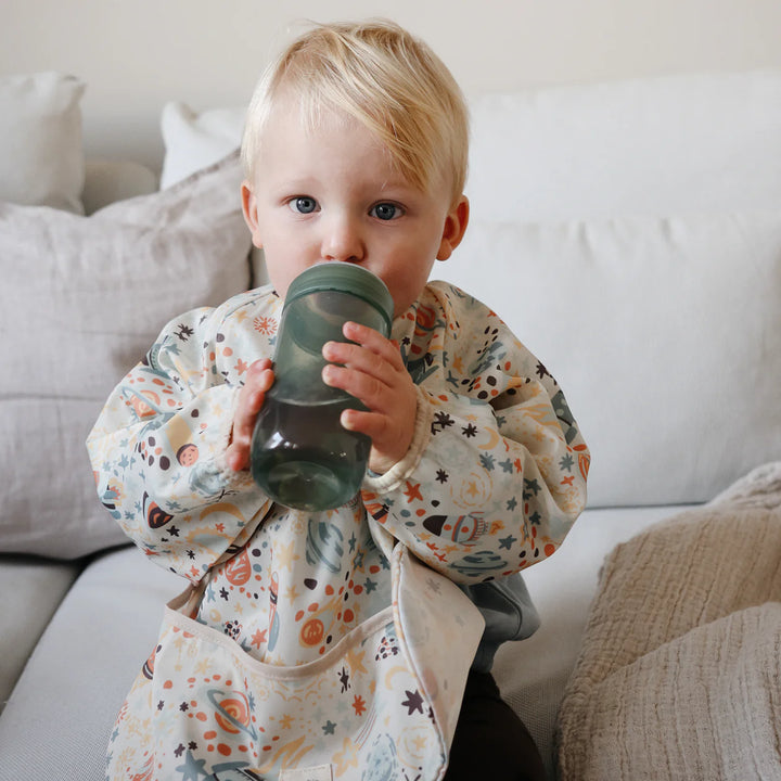Mushie Soft Spout Sippy Cup space shoot lifestyle - toddler drinking from BPA-free spill-resistant sippy cup