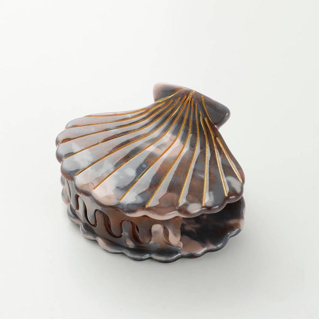 Adorro Calacatta Seashell Claw Clip Small styled flat lay on neutral background showing earthy marbled texture and seashell shape hair accessory
