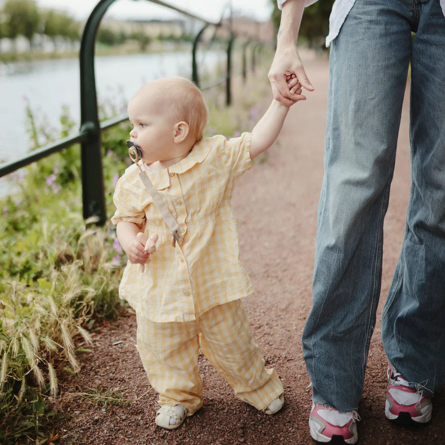 Shifting Sand Mushie Linen Pacifier Clip keeps your baby pacifier secure and stylish on the go.
