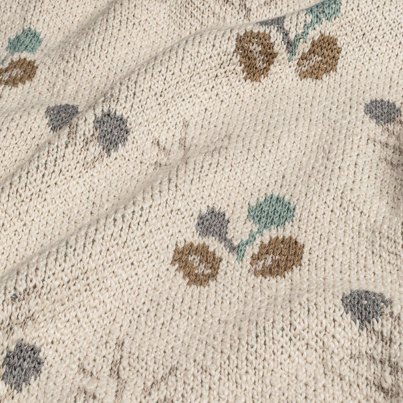 close up of crane organics baby blanket with green and brown poppy seed pattern 