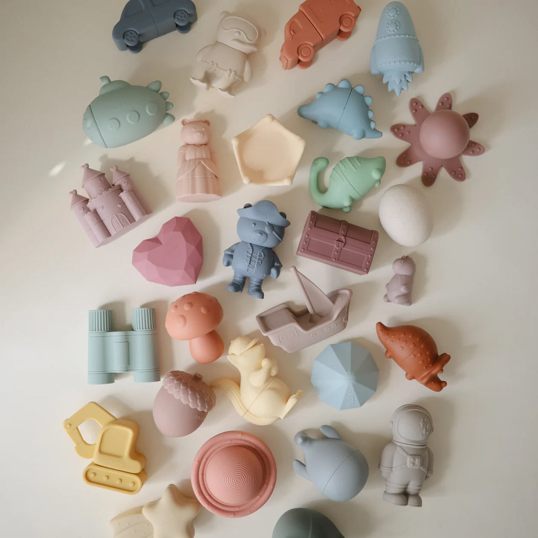 Mushie Pirate Bath Set styled flat lay - pirate-themed silicone bath toys with summer bath time accessories