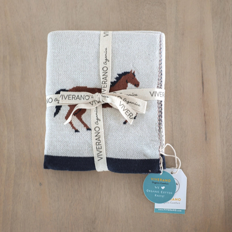 Warm up with the Viverano Organics Organic Cotton Jacquard Knit Baby Blanket in Horse, a charming and cozy plush knit baby blanket.