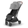 Stroll in style with the UPPAbaby Minu V3 Greyson, sunshade extended for extra coverage.