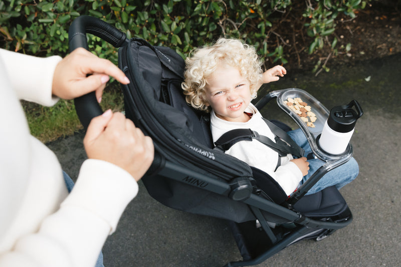 Snack tray on UPPAbaby Minu V3 Jake in Jake, a baby stroller with added convenience for parents.