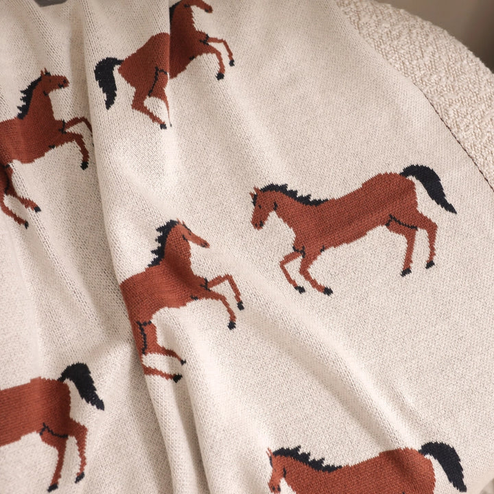 Made from organic cotton, this Viverano Organics blanket in Horse is a soft, knitted baby blanket for all seasons.