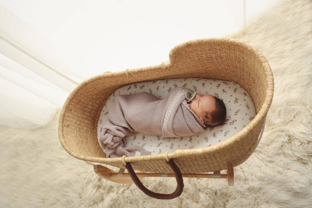 Newborn baby in crib swaddled in the Heritage Knit 100% Organic Cotton Swaddle Baby Blanket and receiving blanket