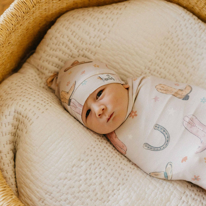Copper Pearl Cheyenne 46x46 muslin-style knit swaddle blanket in soft gender-neutral tones