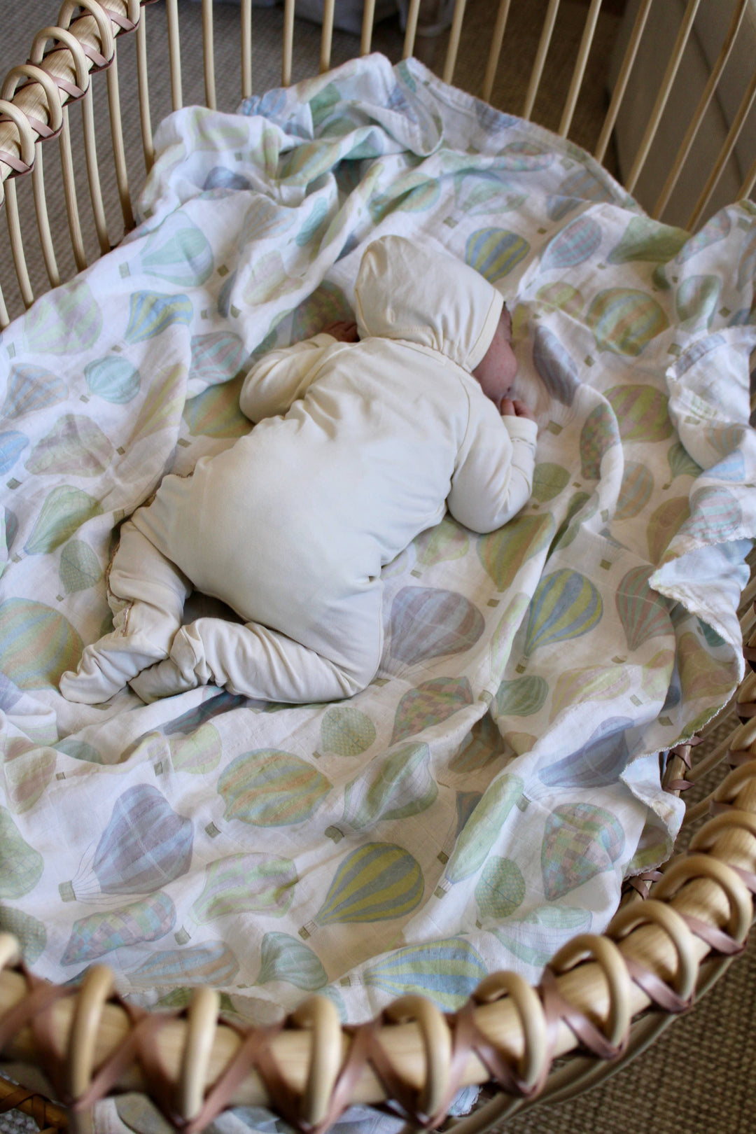 Little Threads pastel air balloon swaddle blanket in Moses basket, soft muslin baby blanket for nursery decor and newborn essentials