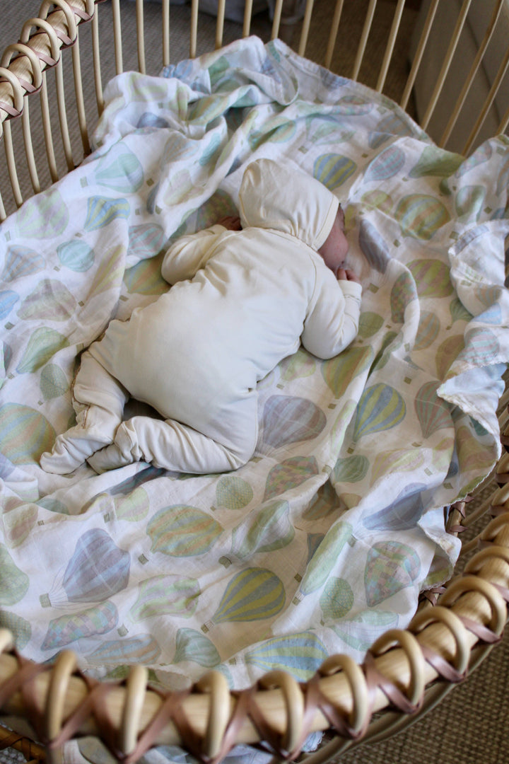 Little Threads pastel air balloon swaddle blanket in Moses basket, soft muslin baby blanket for nursery decor and newborn essentials