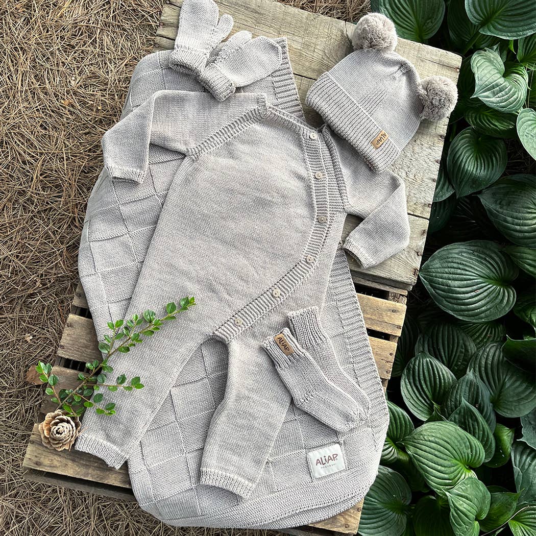 Flat lay of a grey knit baby outfit with matching hat, ALIAP Merino Wool Plain Knit Baby Bodysuit, layette gift idea