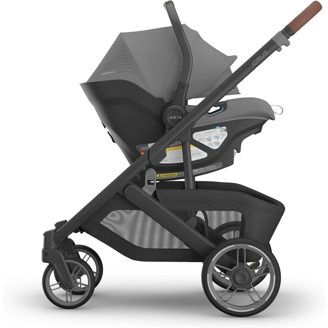 Effortlessly mounted to the Cruz stroller, the Uppababy Aria V2 in Greyson shines as a versatile rear facing car seat.