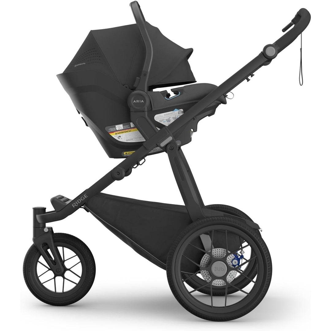 Side angle of the Uppababy Aria V2 Infant Car Seat in Jake on Ridge stroller, built for adventure and safety.