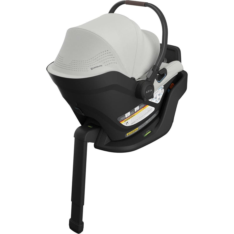 Three-quarter rear view of the Uppababy Aria V2 Infant Car Seat in Savannah highlights elegant design and cozy padding.