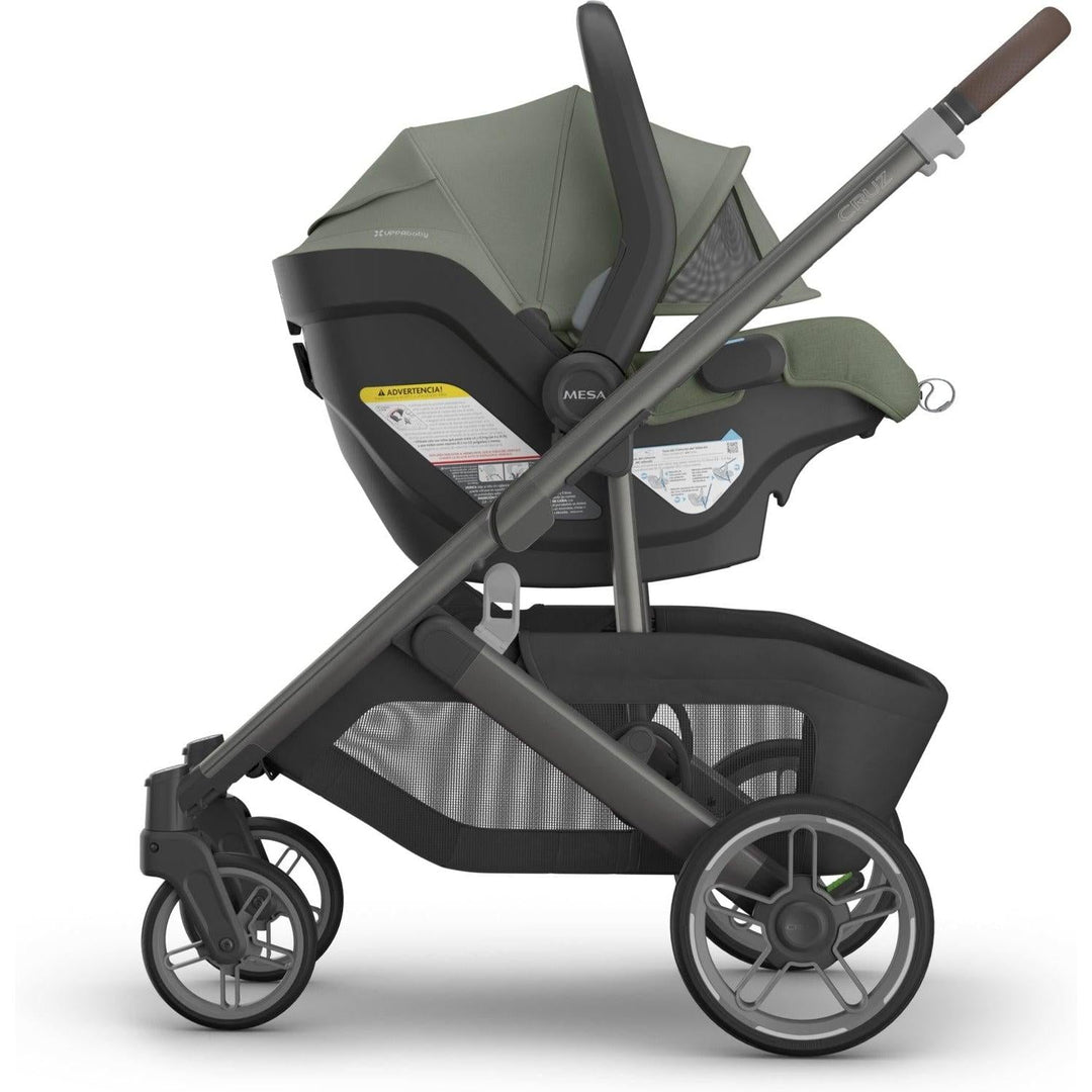 Uppababy Aria V2 Infant Car Seat in Evelyn connected to Cruz stroller base, combining elegant styling with everyday usability.
