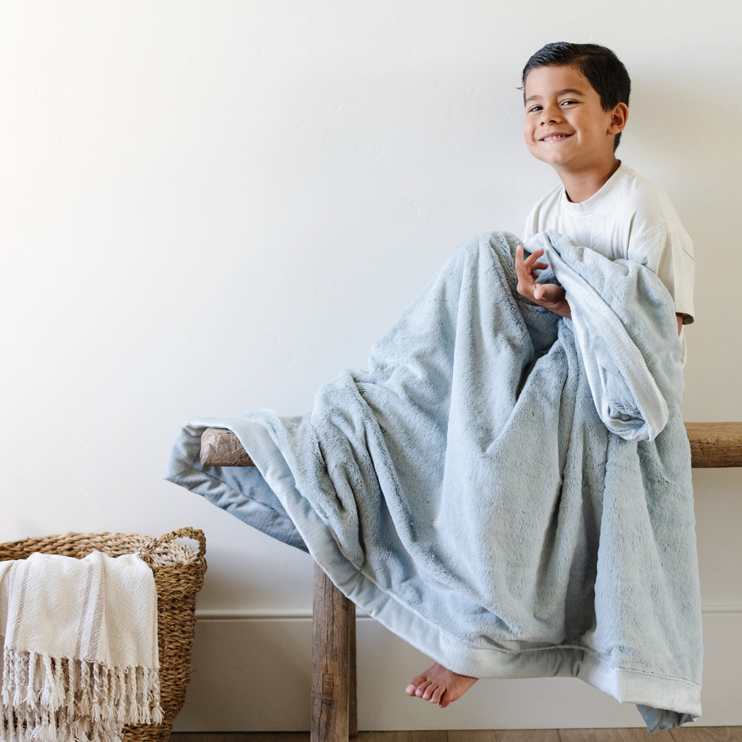 Keep toddlers snug with the Saranoni Lush Toddler Blanket in Chambray, a top choice for best toddler blankets.