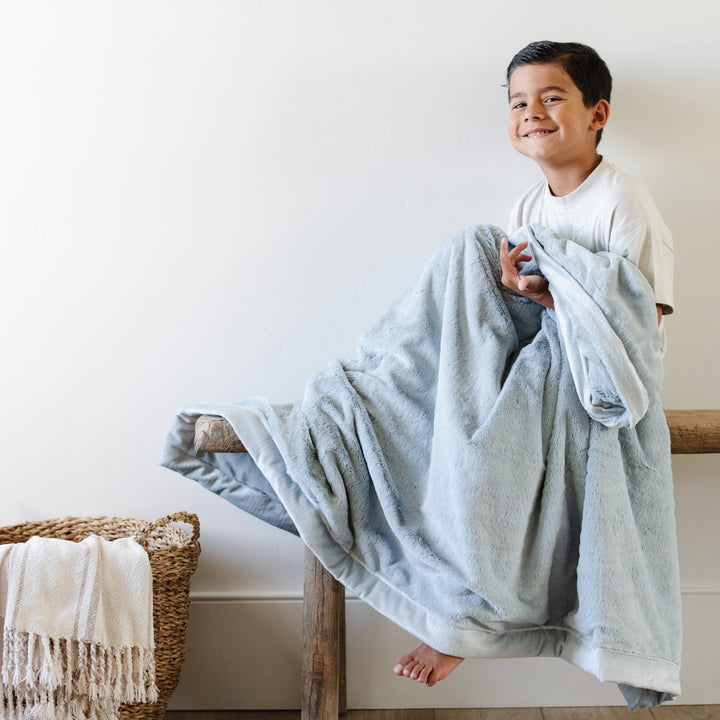 Keep toddlers snug with the Saranoni Lush Toddler Blanket in Chambray, a top choice for best toddler blankets.