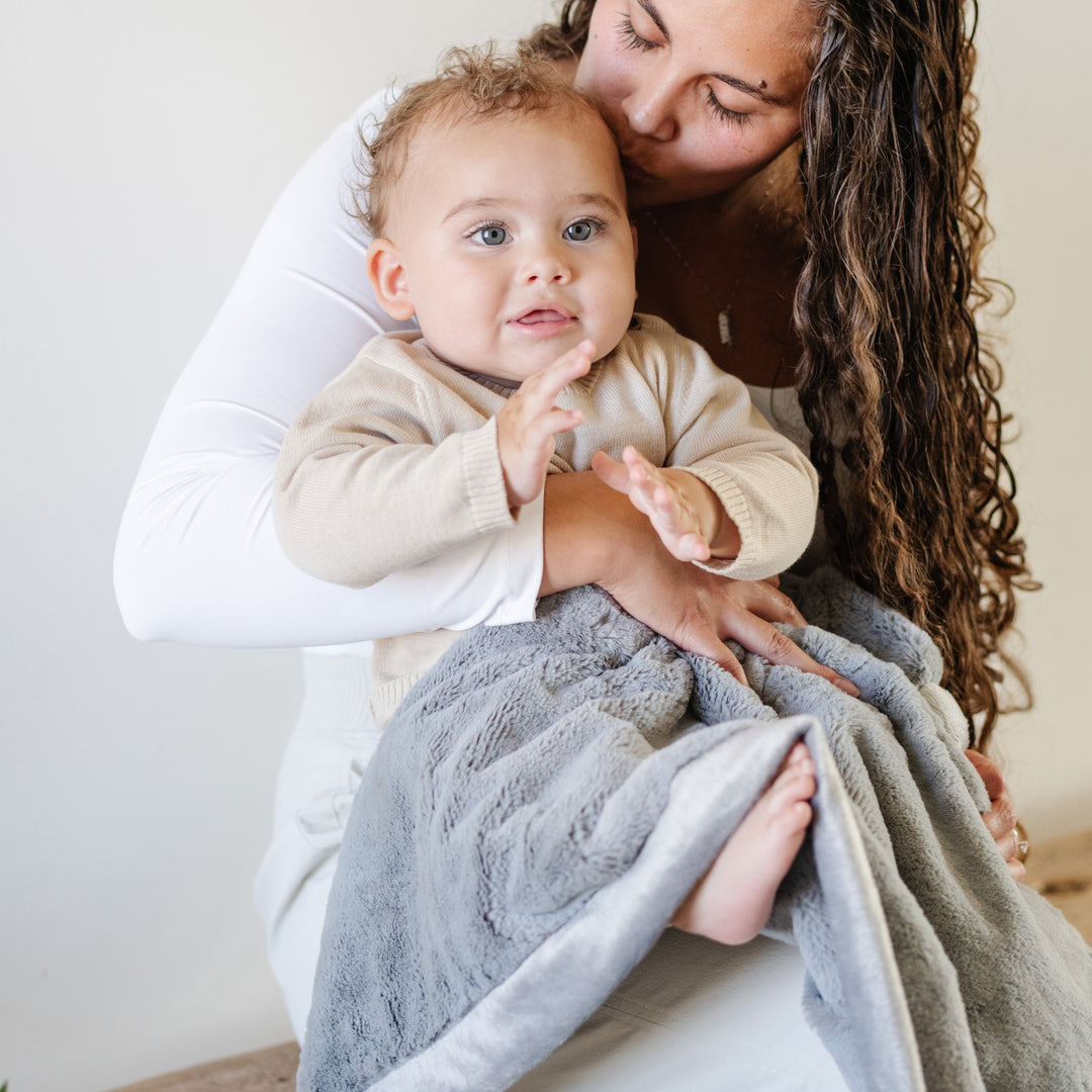 The Gray Saranoni Lush Receiving Blanket offers warmth and softness, a cozy best blanket for toddler.