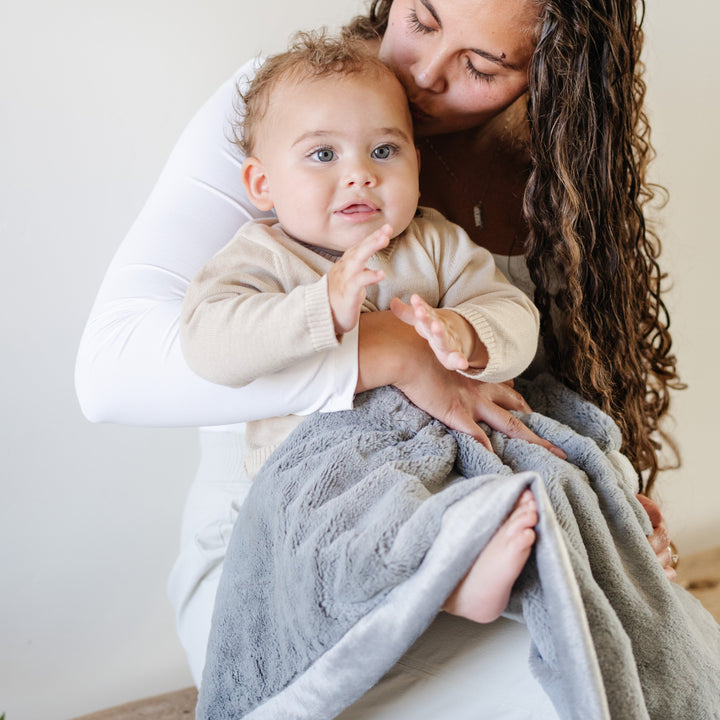The Gray Saranoni Lush Receiving Blanket offers warmth and softness, a cozy best blanket for toddler.