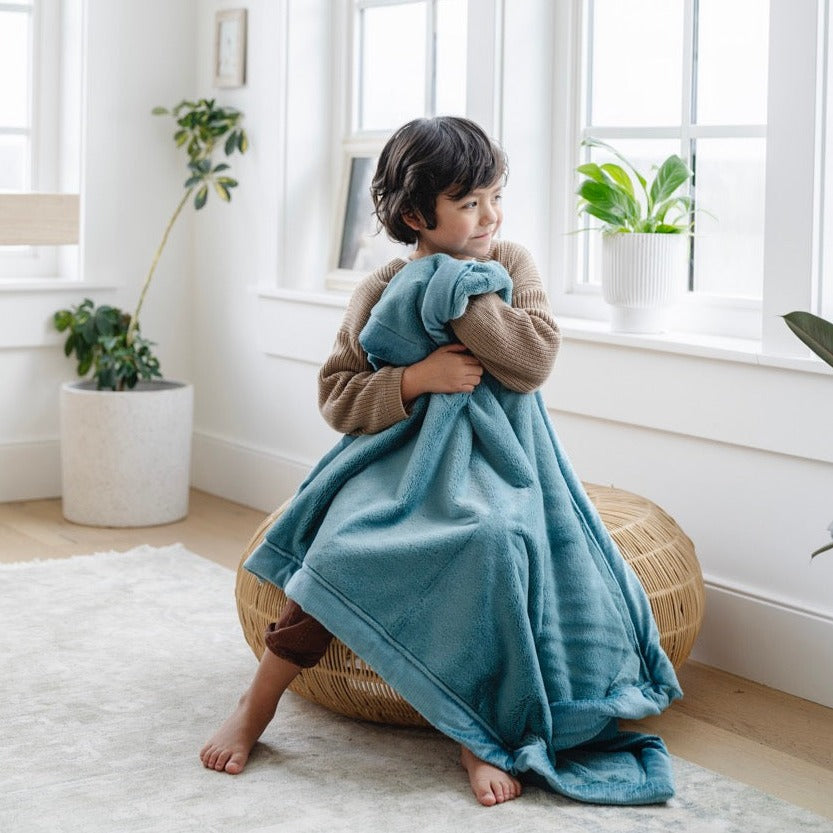 Cuddle infants in the Mineral Blue Saranoni Lush Receiving Blanket, perfect as baby receiving blankets for comfort.