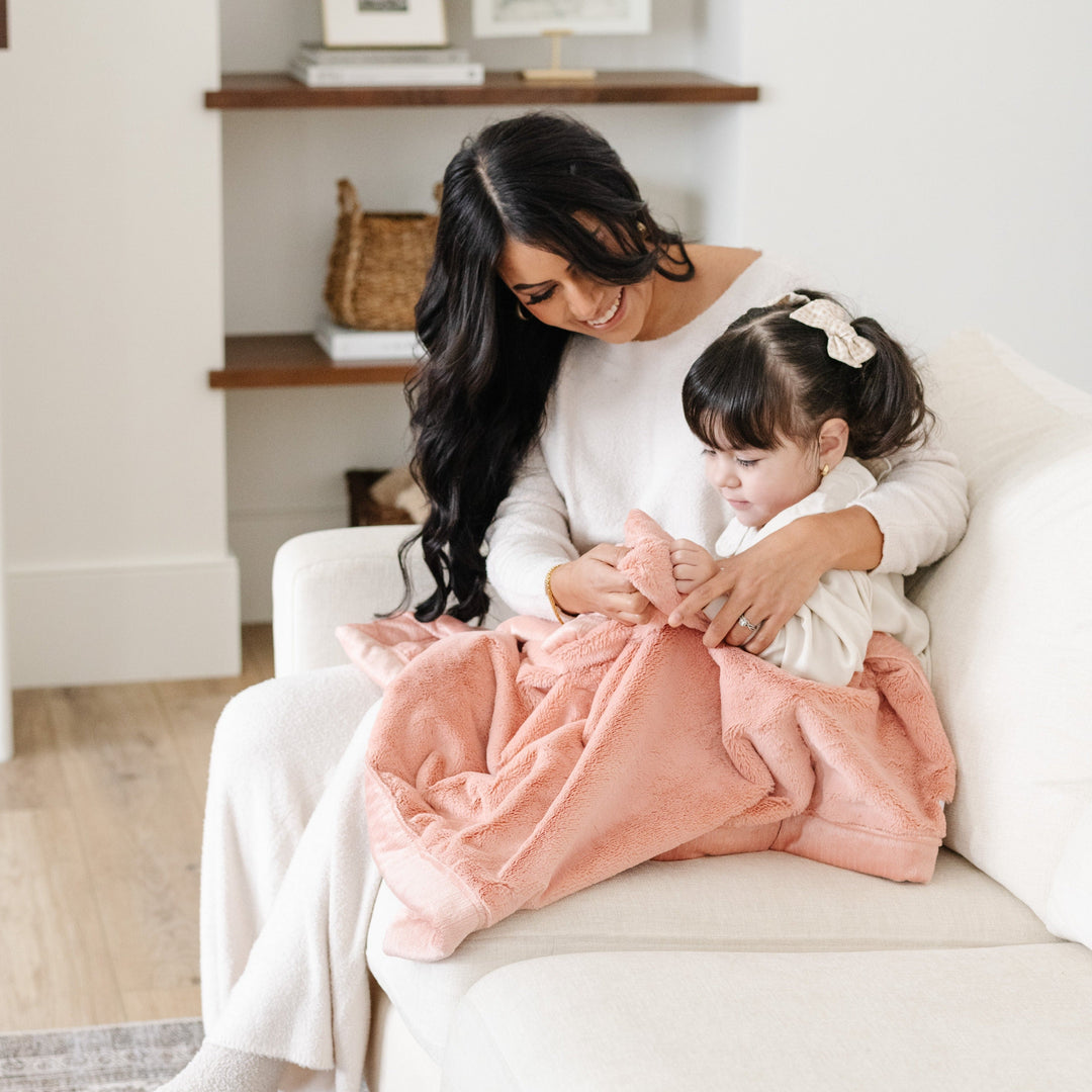 Snuggle your baby with Blossom Saranoni Lush Receiving Blanket, a gentle and warm baby blanket.