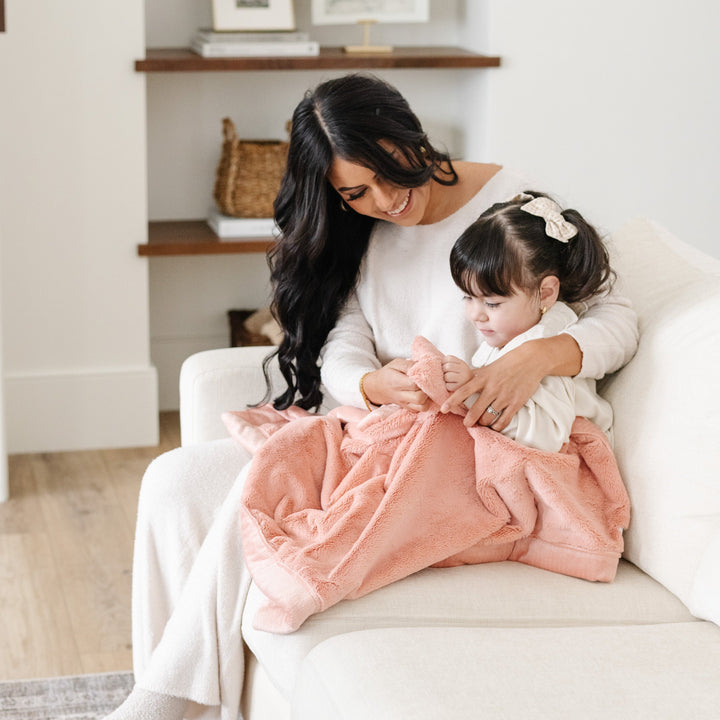 Snuggle your baby with Blossom Saranoni Lush Receiving Blanket, a gentle and warm baby blanket.