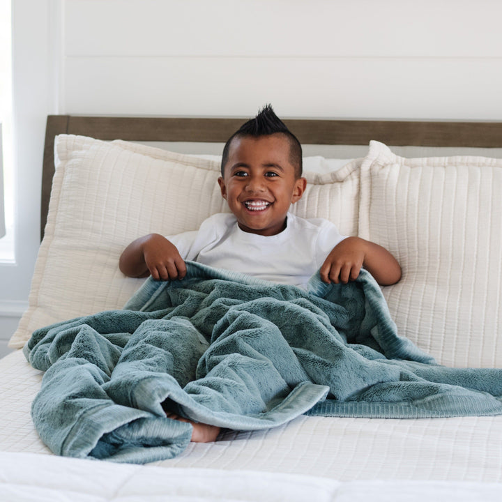 The Saranoni Lush Toddler Blanket in Eucalyptus gives plush texture and warmth parents love for baby blankets.