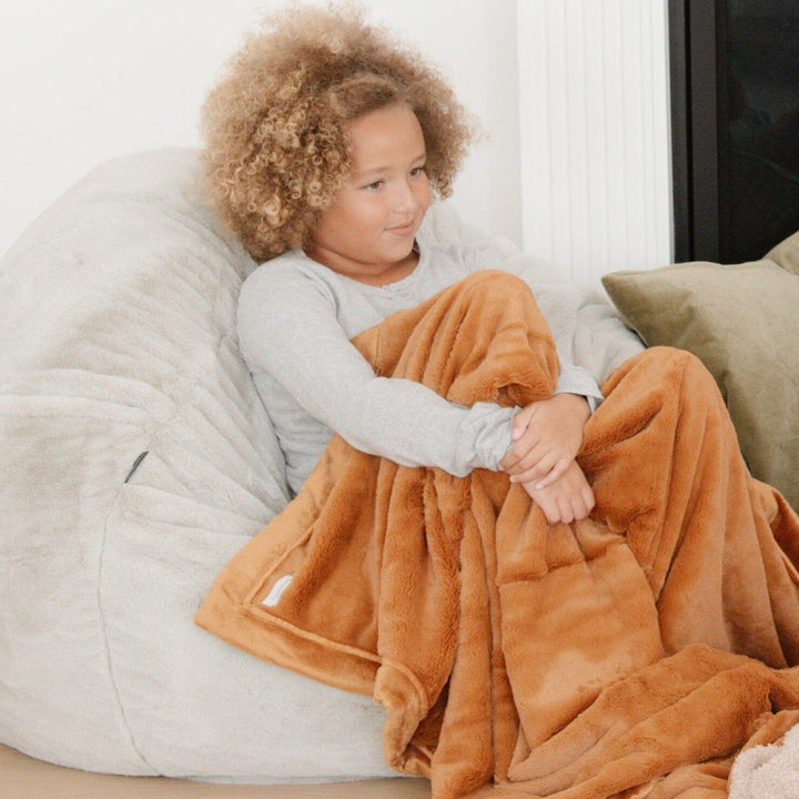 Camel showcases the Saranoni Lush Toddler Blanket, designed for toddler blankets that feel better than standard fleece.