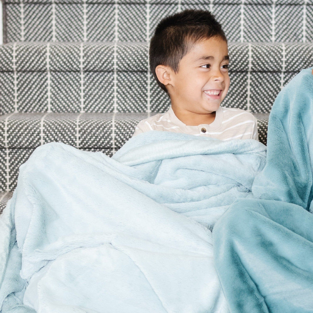 Wrap your little one in the Saranoni Lush Toddler Blanket in Chambray, a cozy toddler blanket for naps and play.