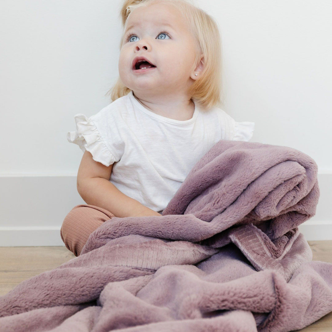 Keep little ones cozy with the Bloom Saranoni Lush Receiving Blanket, a plush newborn receiving blanket.