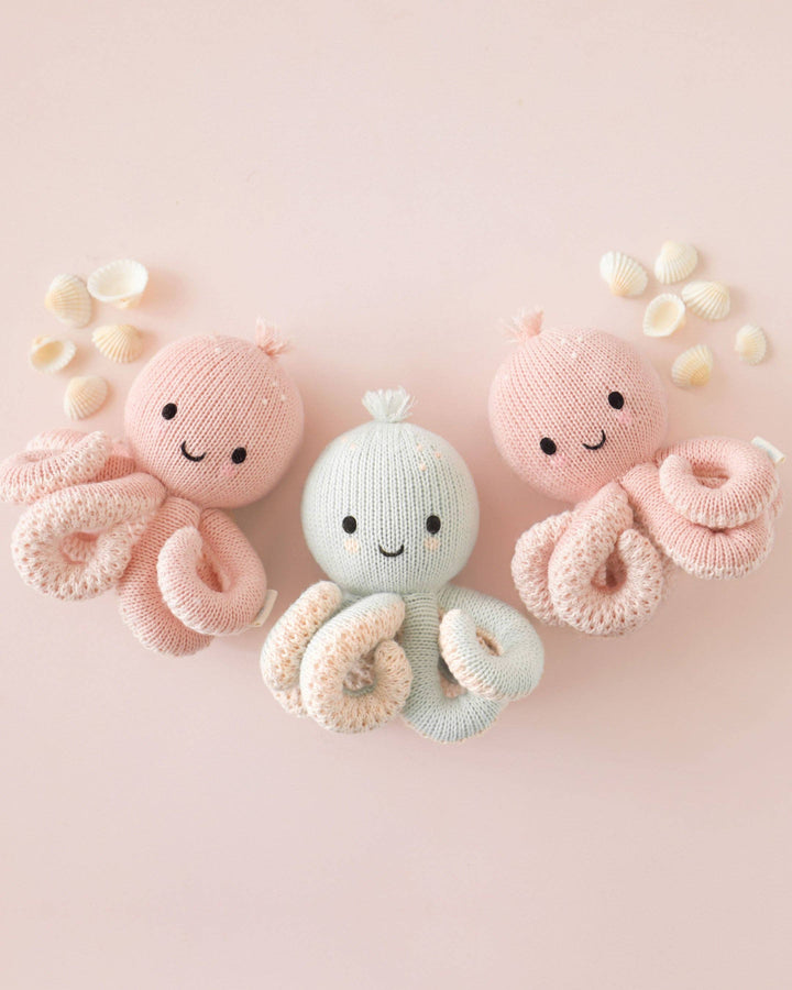 Cuddle + Kind Baby Octopus in Soft Coral Pink handmade fair trade octopus stuffed animal for newborns