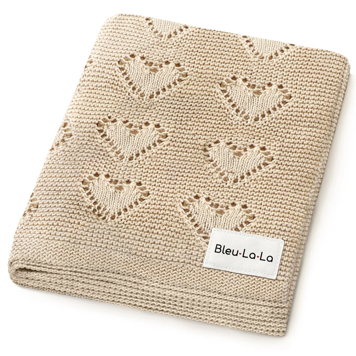 Bleu La La 100% Cotton Luxury Knit Heart Swaddle Baby Blanket in oatmeal, folded to display heart knit design and durable cotton.