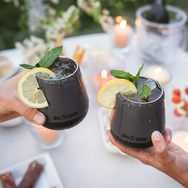 Friends toasting with Klean Kanteen 10oz Rise Wine Tumblers in Asphalt, featuring minimalist stainless steel design