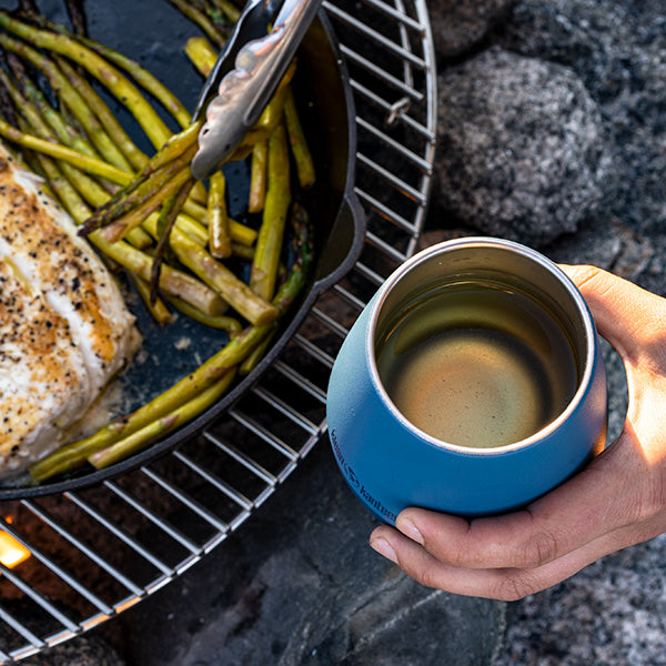 Grilled fish beside Klean Kanteen 10oz Rise Wine Tumbler in Stellar, showcasing vacuum insulation and outdoor durability