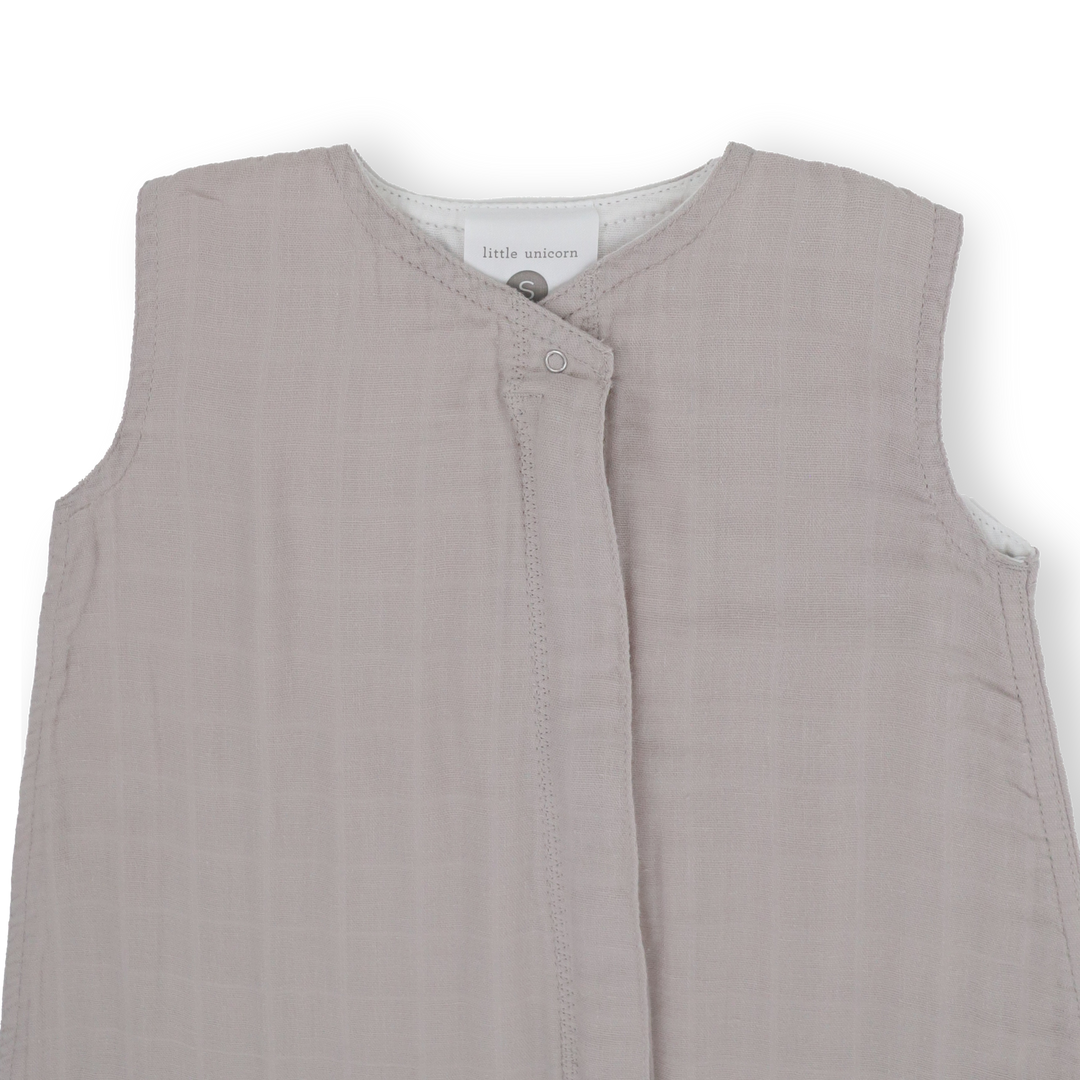 Flat lay of Little Unicorn Cotton Muslin Sleep Bag - Porpoise, infant sleeping bag ideal for nursery use.