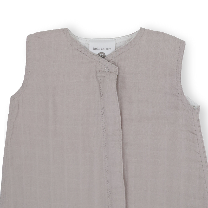 Flat lay of Little Unicorn Cotton Muslin Sleep Bag - Porpoise, infant sleeping bag ideal for nursery use.