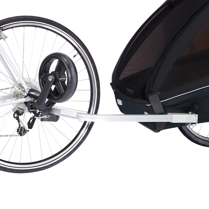 Black Thule Coaster XT bike trailer for two kids with ezHitch axle mount