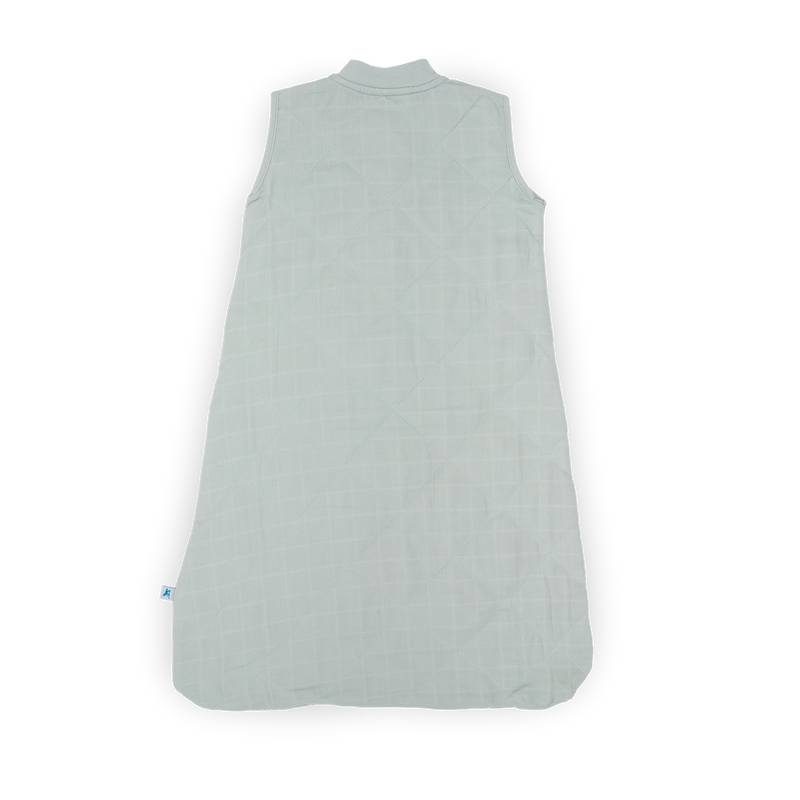 Flat lay of Little Unicorn Cotton Muslin Quilted Sleep Bag - Sea Salt, lightweight and gentle baby sleeping bags.