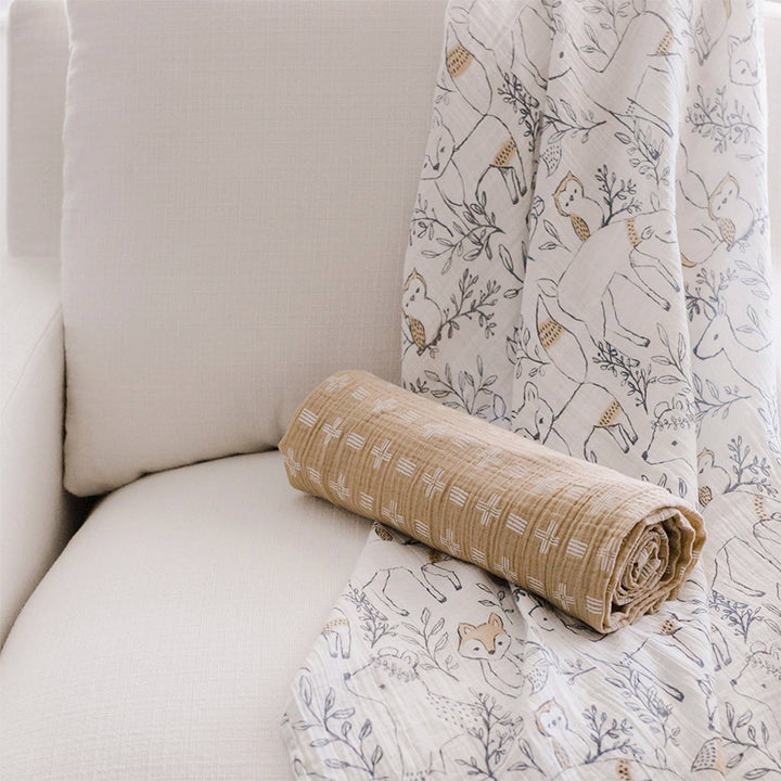 ezra brown and grey woodland creature illustrated whimsical crane baby cotton swaddle