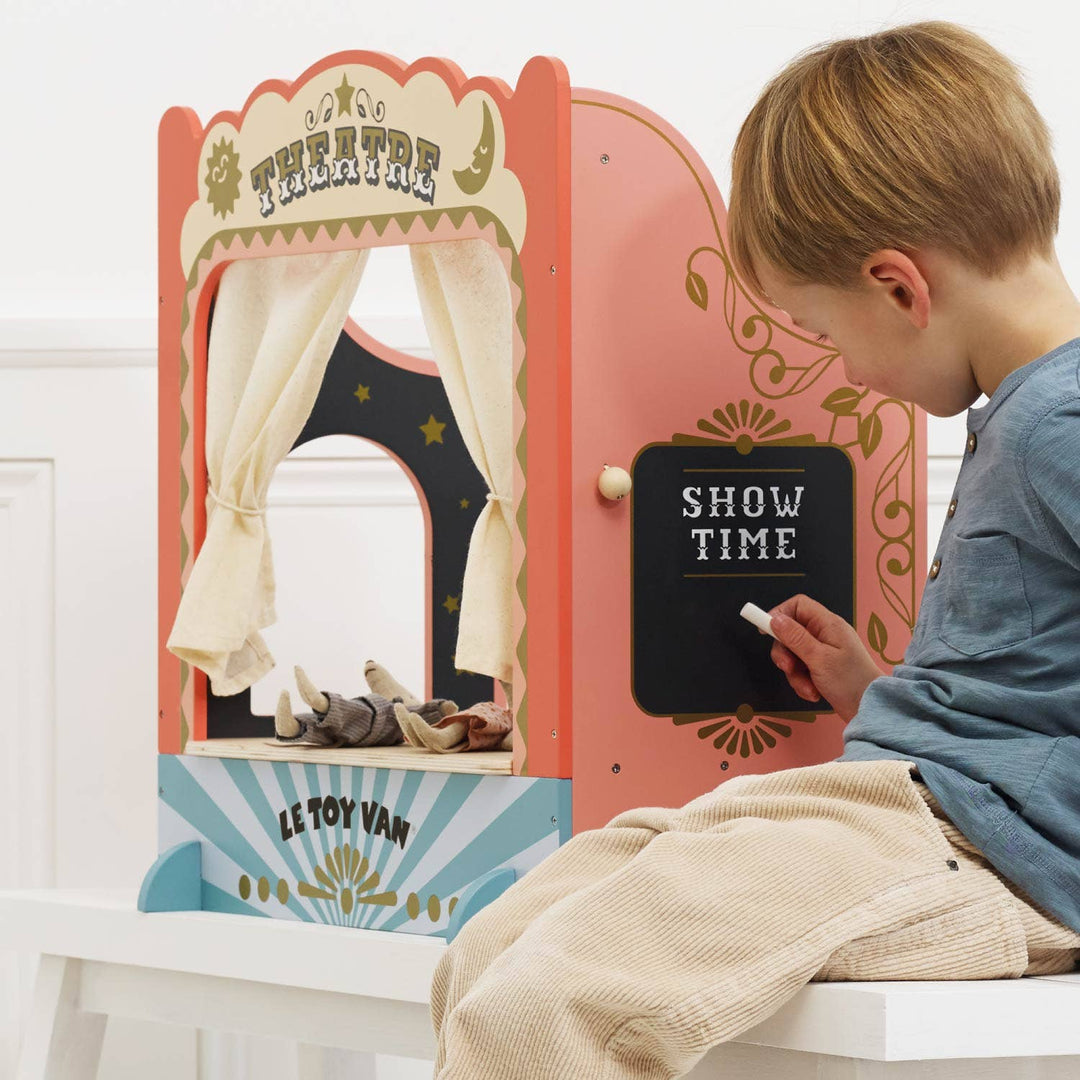 Le Toy Van Tabletop Puppet Theatre lifestyle shot with child performing puppet show