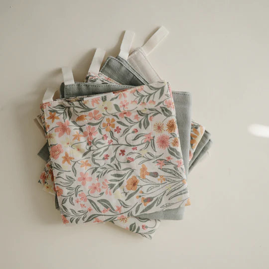 Newborn wrapped in towel with Mushie Muslin Cotton Washcloth - soft organic cotton washcloth set for sensitive baby skin