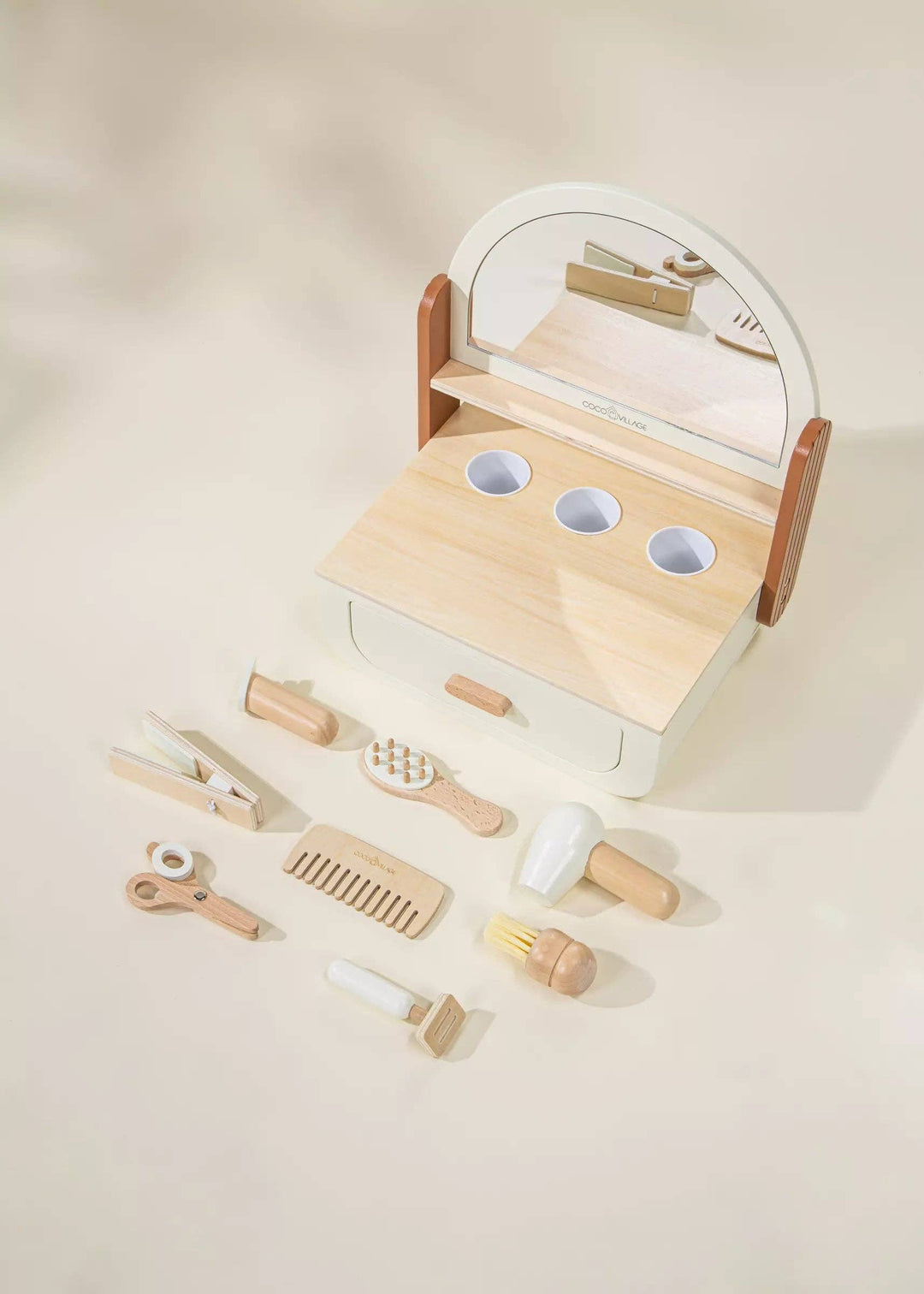 Crafted in a Peach finish, the Coco Village Wooden Beauty Station Playset brings natural beauty and Montessori toy principles to playtime.