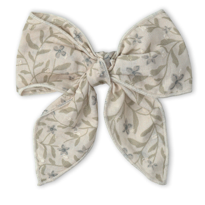 Baby wearing the MakeMake Organics Bluebelle Hair Bow Clip - soft organic cotton toddler hair clip
