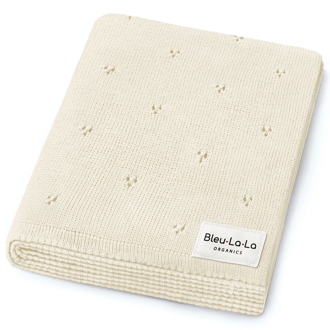 Bleu La La Organic Pointelle Luxury Knit Swaddle Blanket in butter cream, neatly folded to highlight organic cotton softness.