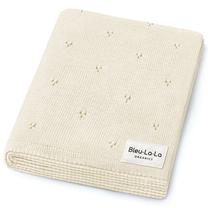 Bleu La La Organic Pointelle Luxury Knit Swaddle Blanket in butter cream, neatly folded to highlight organic cotton softness.