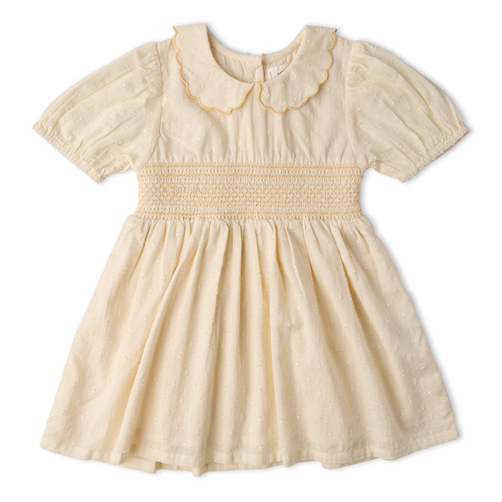 Baby wearing MakeMake Organics Butter Yellow Smocked Dress - heirloom smocking organic toddler dress