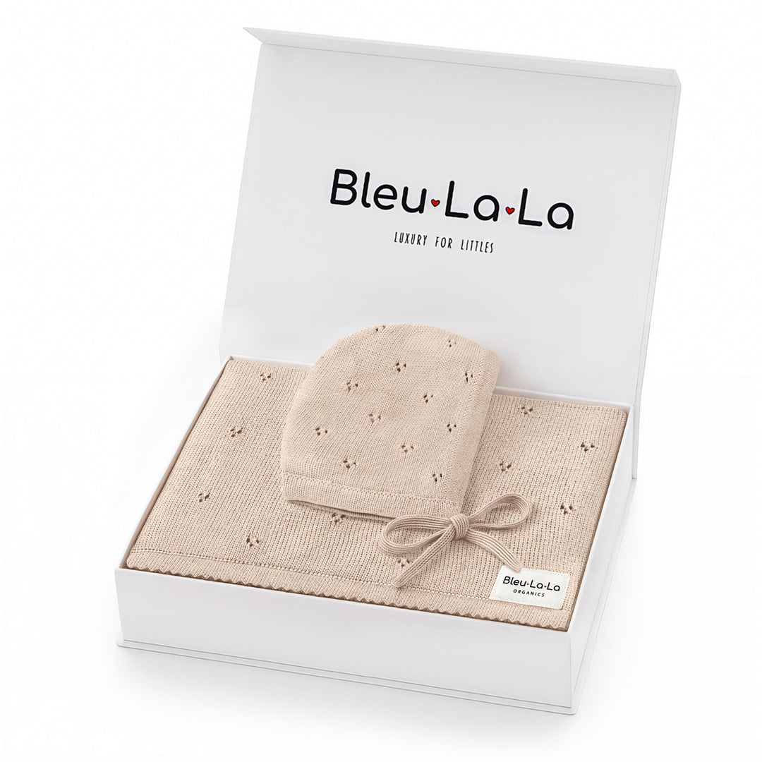 Bleu La La Organic Pointelle Swaddle Blanket + Hat Gift Set in oatmeal, boxed with ribbon for elegant newborn gifting.