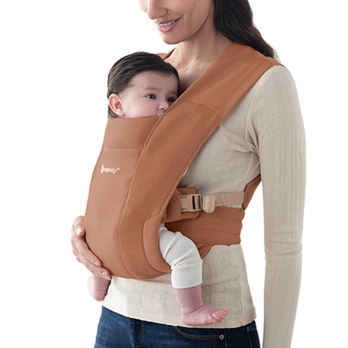 Crafted in Canyon Caly, the Ergobaby Embrace Newborn Carrier is the ultimate newborn baby carrier for early snuggles.
